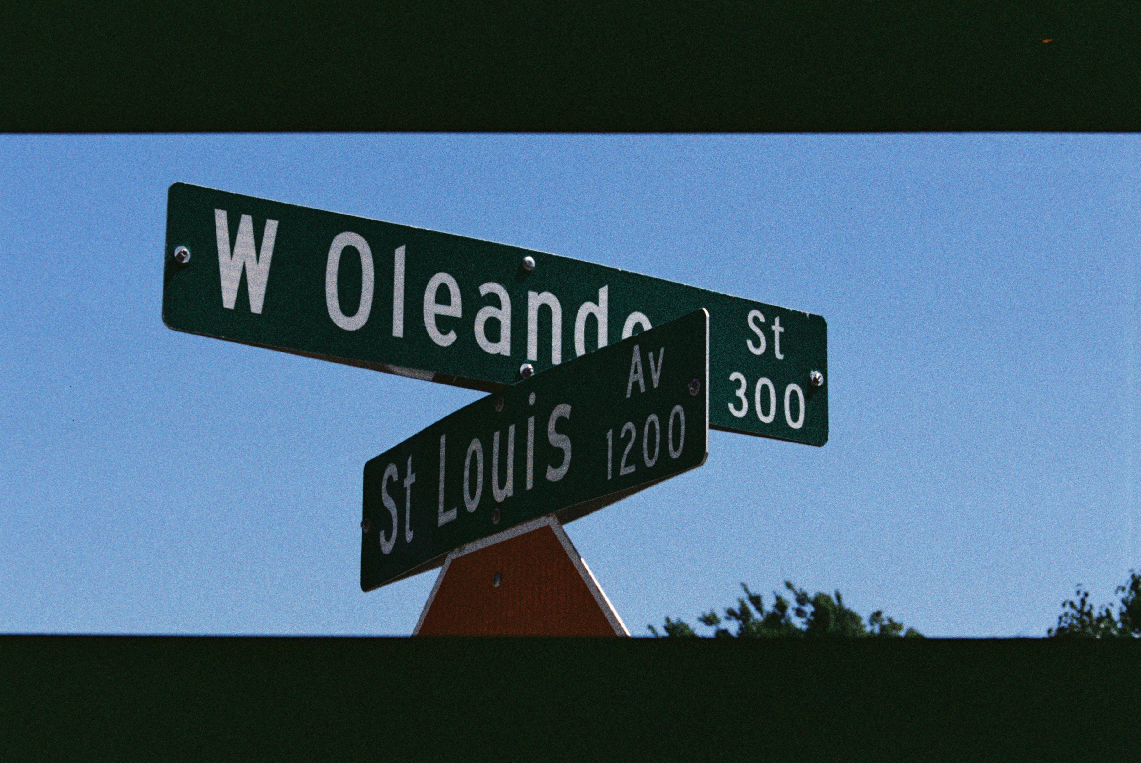 A close-up of a vintage camera on a wooden table.